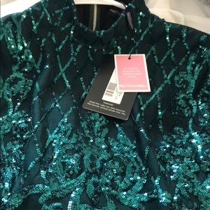 emerald green sequin long sleeve tassel hem bodycon dress